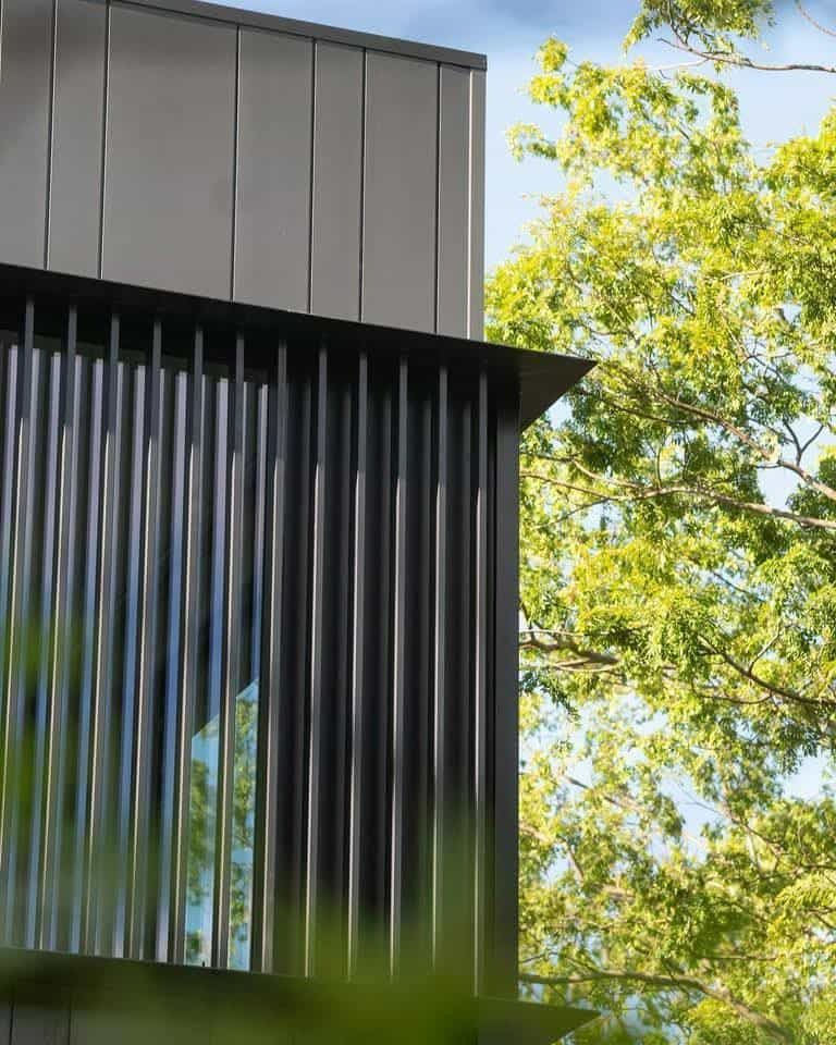 A finished black metal batten facade screen