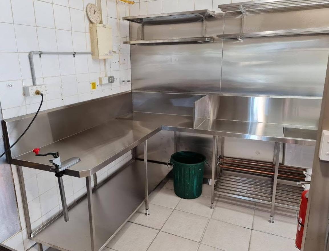 Stainless benches and shelving in a commercial kitchen fitout