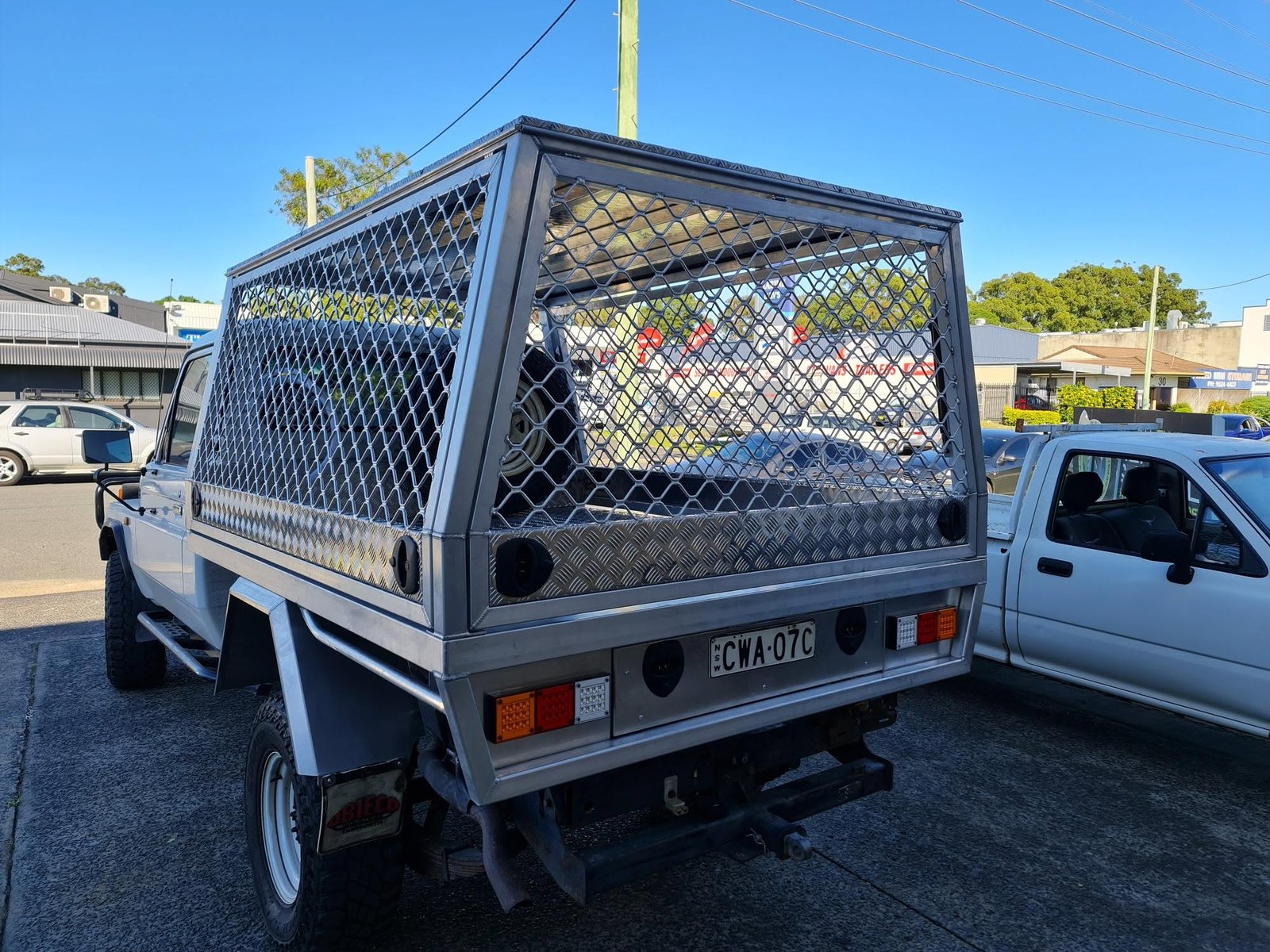 A raw aluminium mesh canopy on a LandCruiser tray