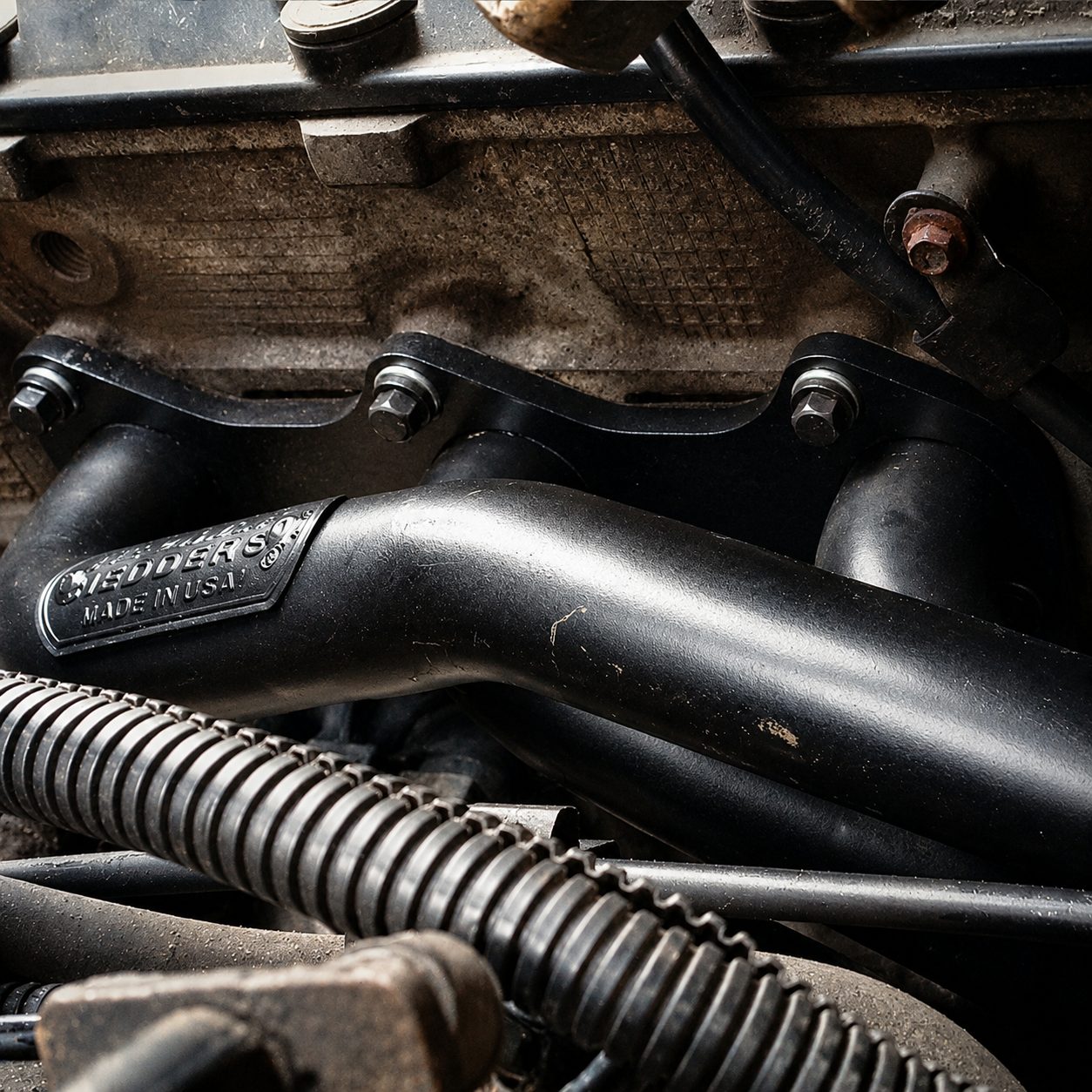 A repaired exhaust manifold in an engine bay