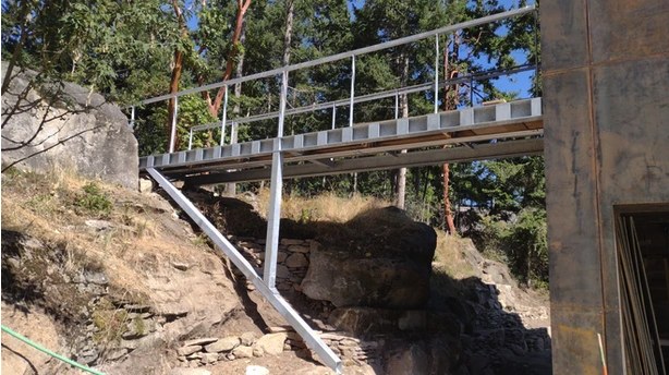 A steel footbridge over rocks