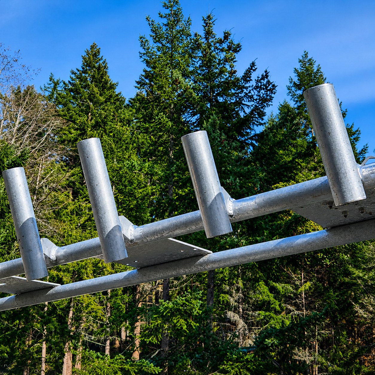 Galvanized steel brackets against the trees