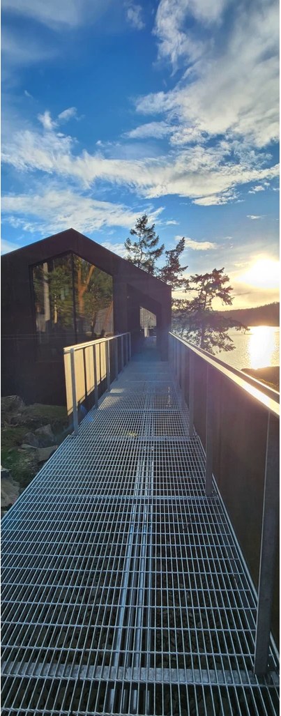 A grated steel walkway at dusk