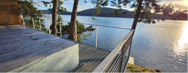 A cable-rail walkway above the water on a recent Mayne Island Metal build