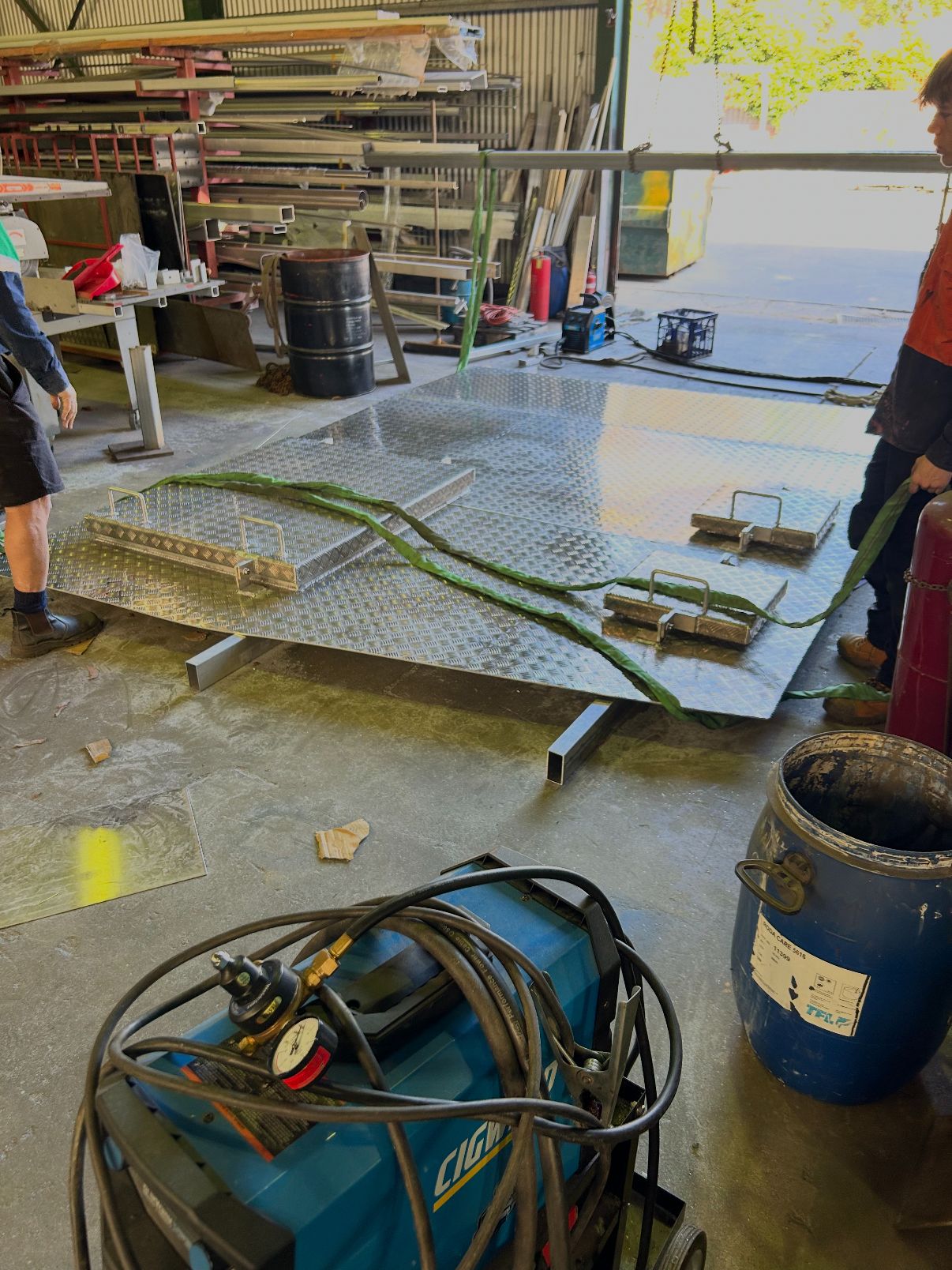 Crew rigging a large aluminium checker-plate deck on the Redcliffe and Offer Steel shop floor