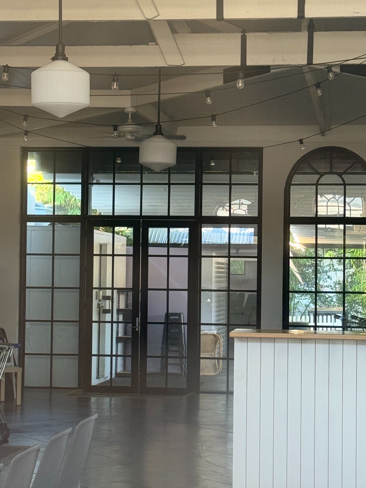 Black steel-framed glazed partition with windows and doors fabricated by Redcliffe and Offer Steel