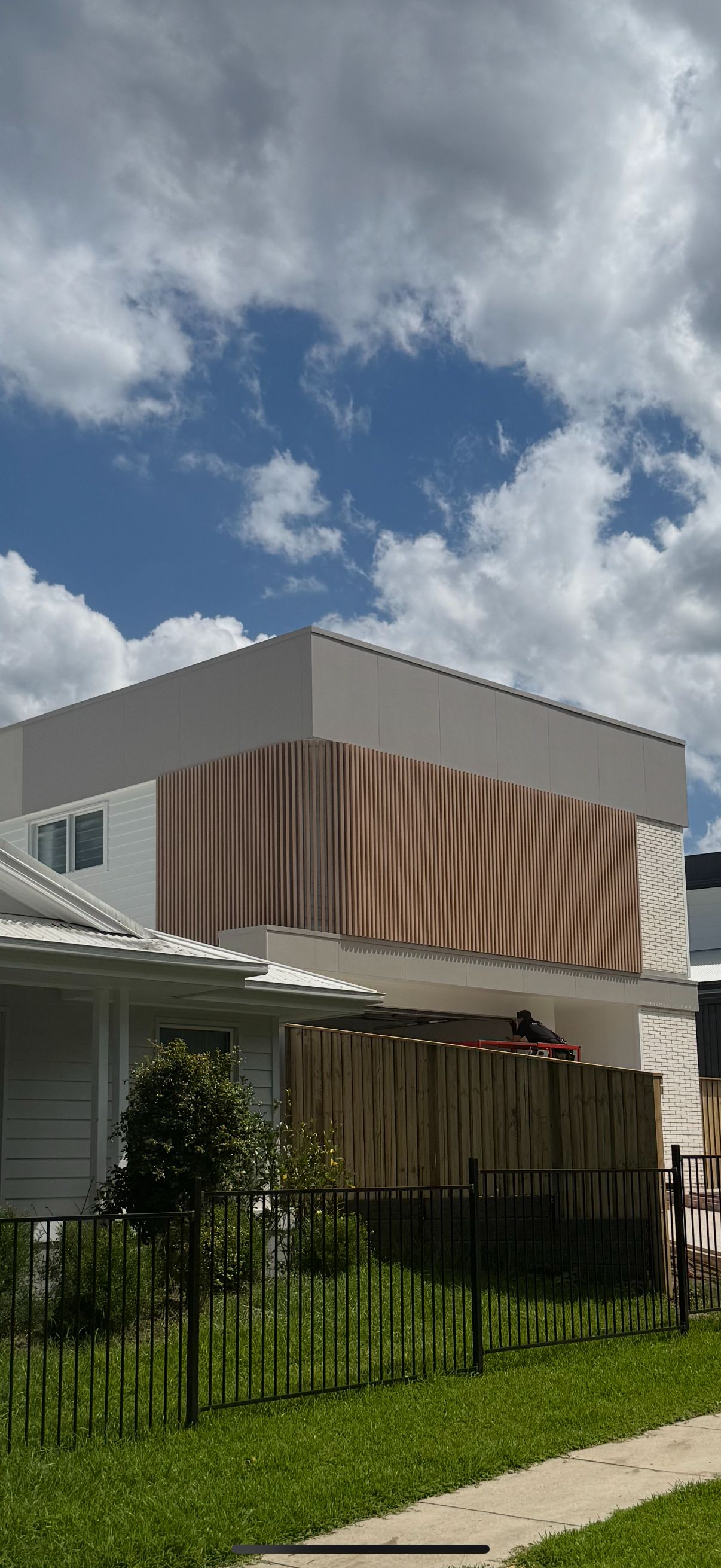 An aluminium batten screen and cladding on a two-storey building