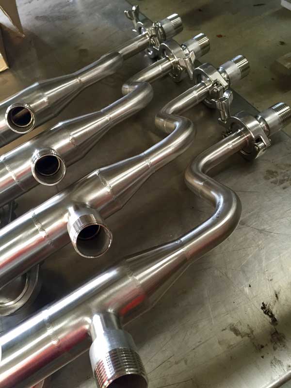 A polished food-grade stainless manifold with tri-clamp fittings