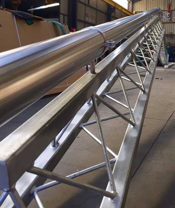 A long stainless-steel conveyor gantry built by Sandwith Industrial Services