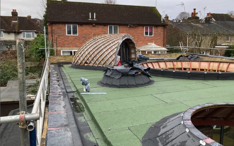 A bespoke curved roof structure under construction
