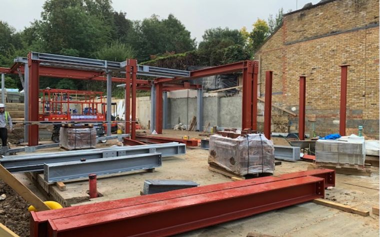 Steelwork going up against an existing building on a Two Js Metalwork site