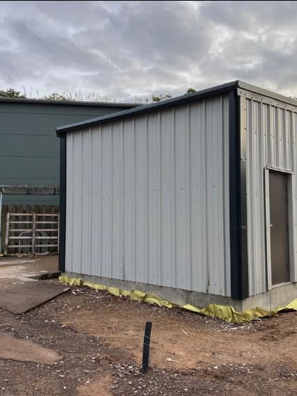 A completed steel-clad outbuilding with roller door